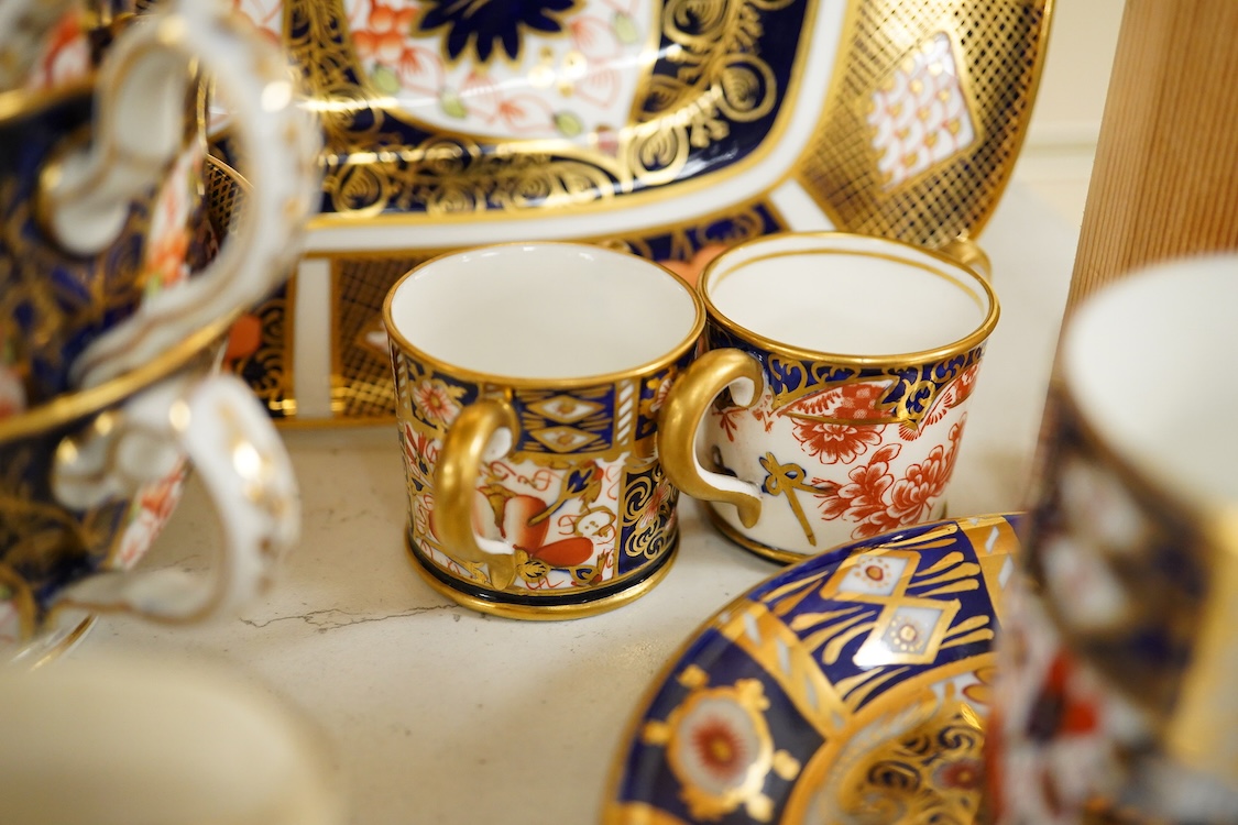 A quantity of Royal Crown Derby Imari to include a sandwich plate, cups and saucers and and miniature twin handled cups, largest 27cm in diameter